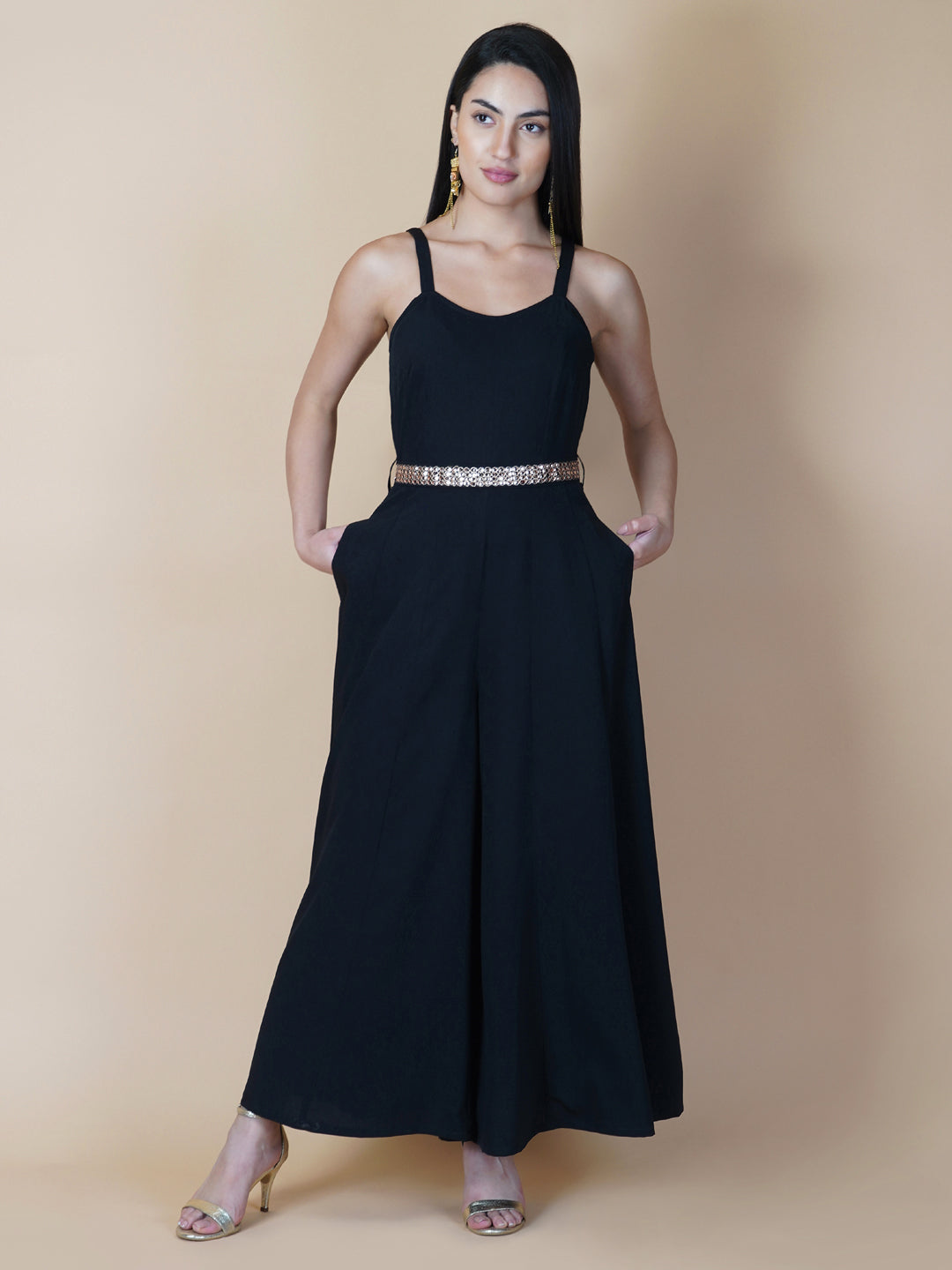 This black solid fit and flare women jumpsuit with an attached belt is a fashionable one-piece garment that combines the comfort of pants with the elegance of a dress. This jumpsuit features a fitted top that flares out into wide-leg pants, creating a flattering silhouette that accentuates the waist and elongates the legs.