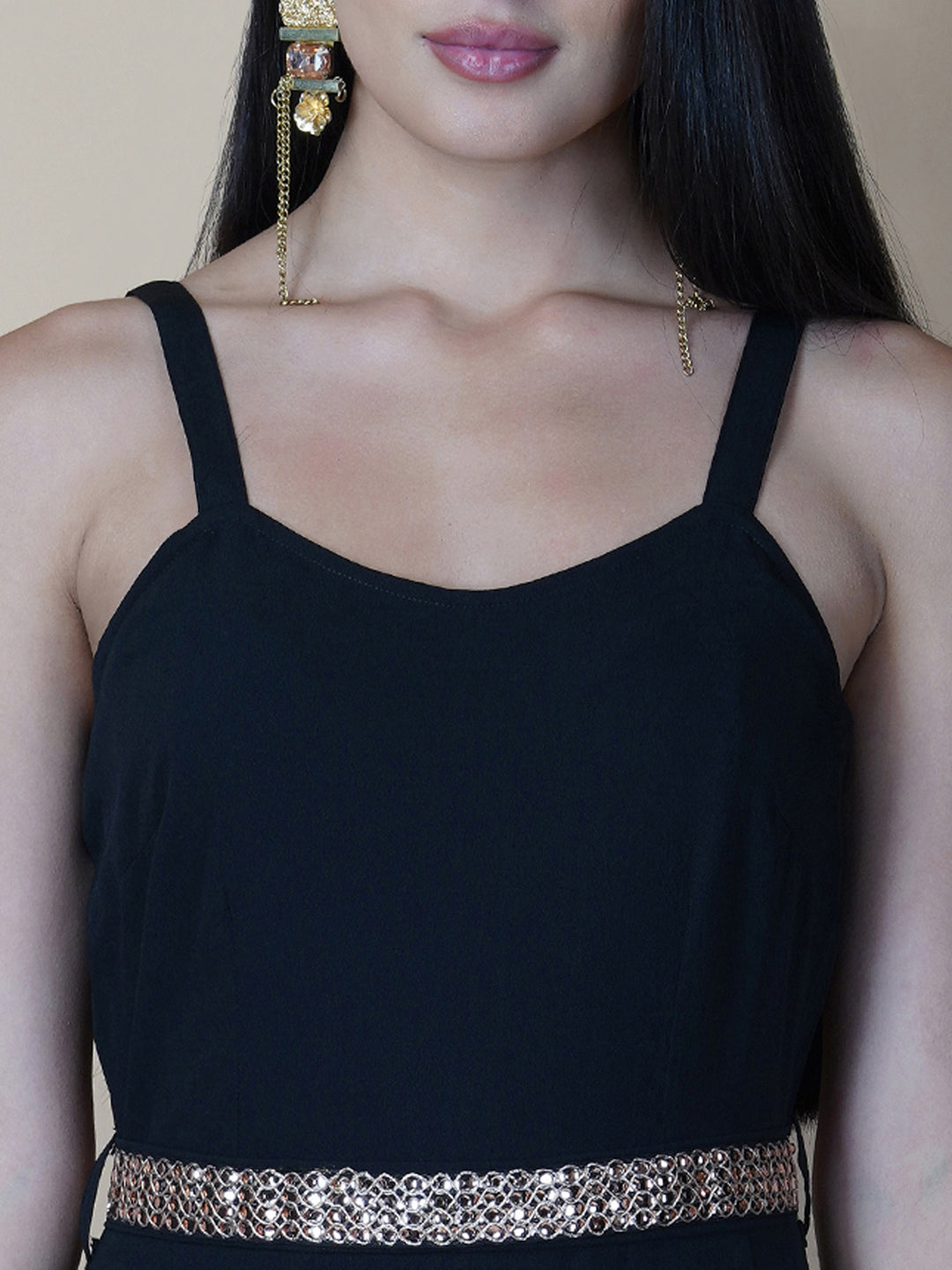 This black solid fit and flare women jumpsuit with an attached belt is a fashionable one-piece garment that combines the comfort of pants with the elegance of a dress. This jumpsuit features a fitted top that flares out into wide-leg pants, creating a flattering silhouette that accentuates the waist and elongates the legs.