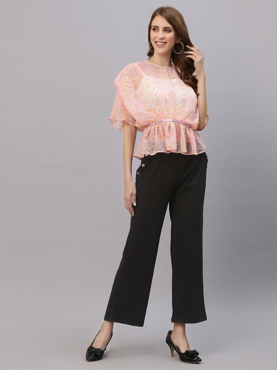 This top features a lightweight and flowy chiffon material that drapes beautifully over the body. The oversized design allows for a comfortable and relaxed fit, while the attached cami provides extra coverage and support. The embellished waist band adds a touch of sparkle and elegance, accentuating the waistline and creating a flattering silhouette. This top is perfect for a variety of occasions, from casual outings to formal events. Pair it with skinny jeans and heels for a chic and stylish look.