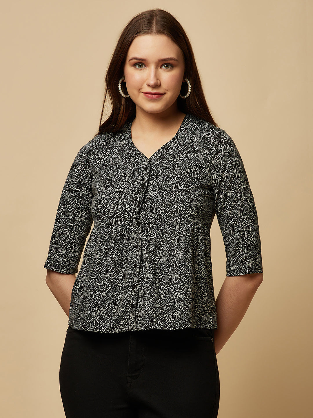 A black printed top with a front placket and ruched bust line is a stylish and elegant piece of clothing. The top has a simple and classic design with a front placket that adds a touch of sophistication to the outfit. The ruched bust line creates a flattering and feminine look, enhancing the wearer's curves.
