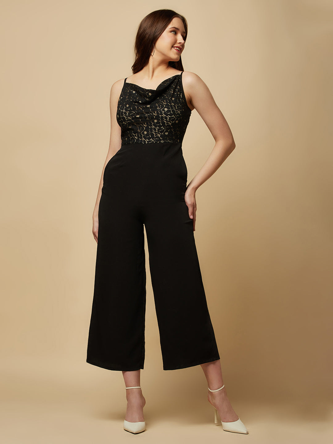 Black cowl neck women jumpsuit with jacquard mesh body and crepe pants is a fashionable piece of clothing that is both elegant and comfortable. The cowl neck provides a flattering neckline that is both feminine and sophisticated.  The jacquard mesh body adds a touch of glamour and texture to the piece, while the crepe pants provide a smooth and comfortable fit.