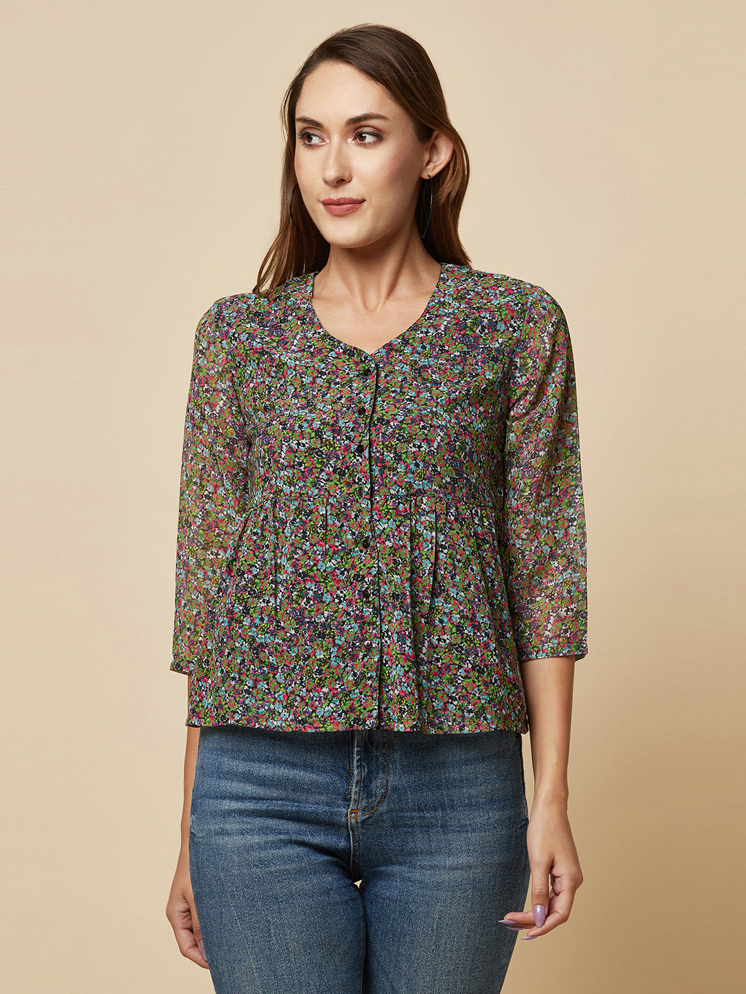 A Green printed top with a front placket and ruched bust line is a stylish and elegant piece of clothing. The top has a simple and classic design with a front placket that adds a touch of sophistication to the outfit. The ruched bust line creates a flattering and feminine look, enhancing the wearer's curves.