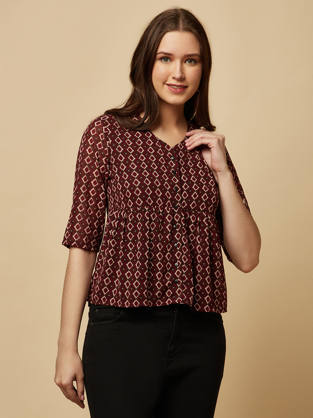 A brown printed top with a front placket and ruched bust line is a stylish and elegant piece of clothing. The top has a simple and classic design with a front placket that adds a touch of sophistication to the outfit. The ruched bust line creates a flattering and feminine look, enhancing the wearer's curves.