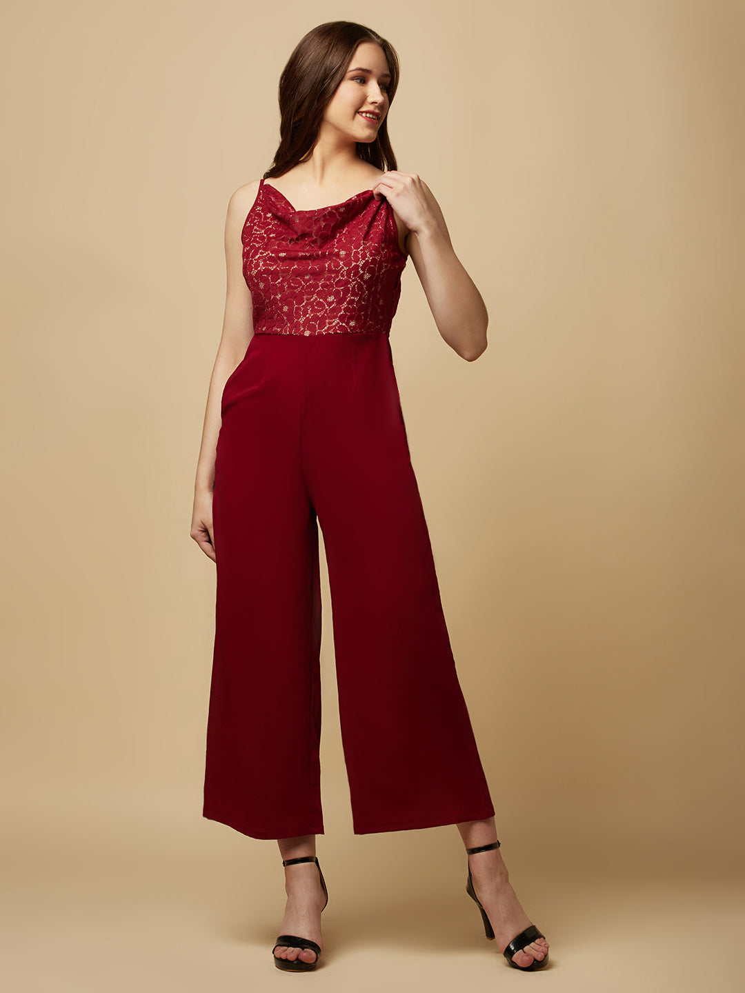 Burgundy cowl neck women jumpsuit with jacquard mesh body and crepe pants is a fashionable piece of clothing that is both elegant and comfortable. The cowl neck provides a flattering neckline that is both feminine and sophisticated.  The jacquard mesh body adds a touch of glamour and texture to the piece, while the crepe pants provide a smooth and comfortable fit.