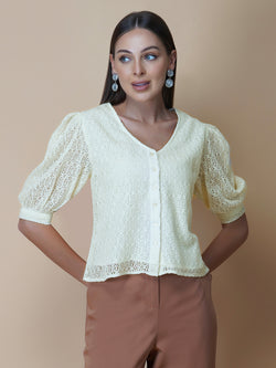 The Ivory Color Jacquard Mesh Women Top is a versatile and stylish piece of clothing that is perfect for both formal and casual occasions. The top features a classic V-neck design that is flattering for all body types, and it is adorned with a row of front buttons that add a touch of elegance and sophistication to the overall look.  Made from good-quality jacquard mesh fabric, this top is lightweight, breathable, and comfortable to wear all day long
