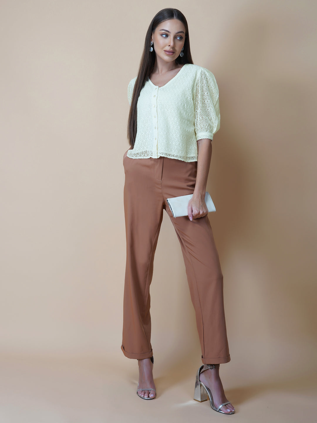 The Ivory Color Jacquard Mesh Women Top is a versatile and stylish piece of clothing that is perfect for both formal and casual occasions. The top features a classic V-neck design that is flattering for all body types, and it is adorned with a row of front buttons that add a touch of elegance and sophistication to the overall look.  Made from good-quality jacquard mesh fabric, this top is lightweight, breathable, and comfortable to wear all day long