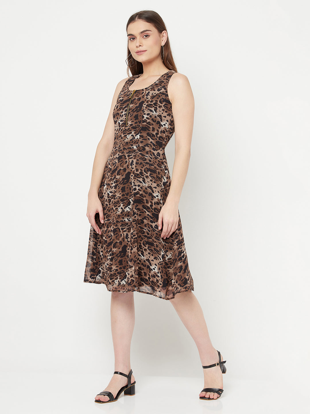 Leopard Print Dress For Women With Attached Lining  Strut about town in this elegant Leopard printed dress for women. Crafted with metallic zip at front neck, the dress features a medium flare with no sleeve.  Leopard print dress for women is a type of dress that features an animal print pattern and has a flattering silhouette that follows the lines of the body, known as the "princess line." It typically falls at or below the knee, creating a midi-length hem.