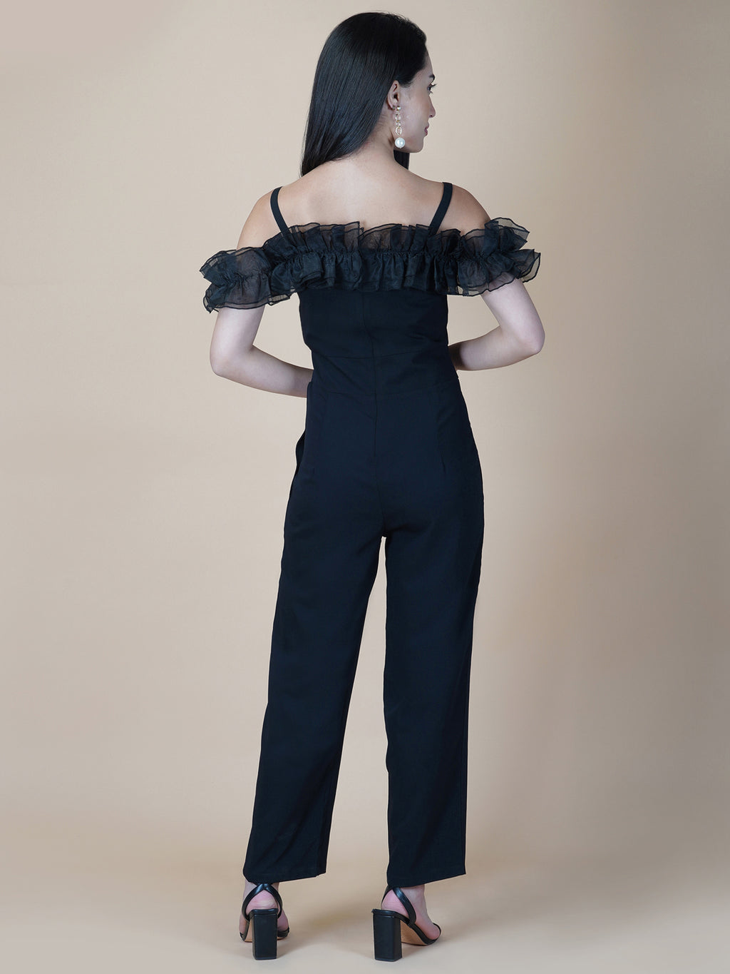 This black solid women's jumpsuit is the perfect combination of comfort and style. This jumpsuit features a tissue ruffle that adds a touch of feminine charm to the outfit. The jumpsuit has a sleeveless design with strap on shoulder, providing a stylish look
