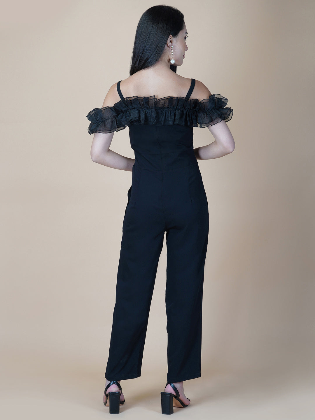 This black solid women's jumpsuit is the perfect combination of comfort and style. This jumpsuit features a tissue ruffle that adds a touch of feminine charm to the outfit. The jumpsuit has a sleeveless design with strap on shoulder, providing a stylish look