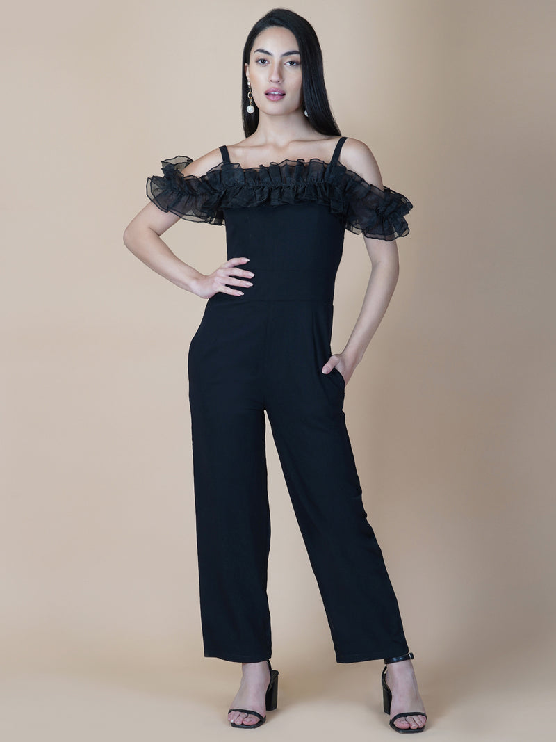 This black solid women's jumpsuit is the perfect combination of comfort and style. This jumpsuit features a tissue ruffle that adds a touch of feminine charm to the outfit. The jumpsuit has a sleeveless design with strap on shoulder, providing a stylish look