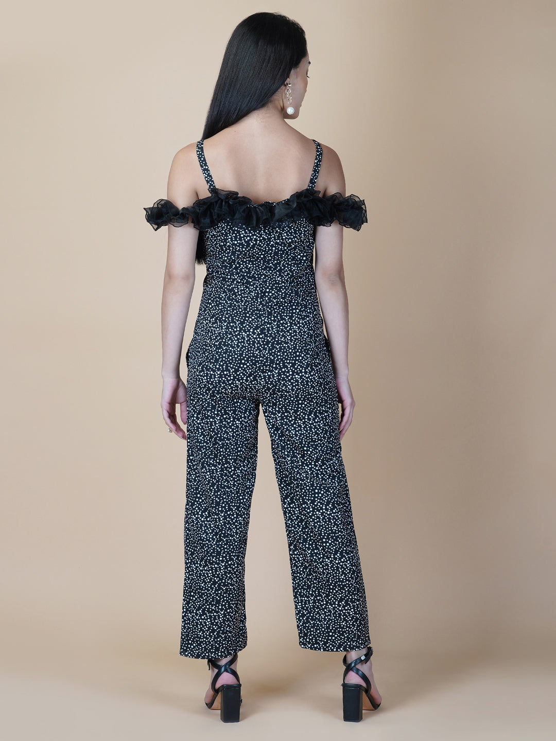 This black and white printed women's jumpsuit is the perfect combination of comfort and style. This jumpsuit features a tissue ruffle that adds a touch of feminine charm to the outfit. The jumpsuit has a sleeveless design with strap on shoulder, providing a stylish look