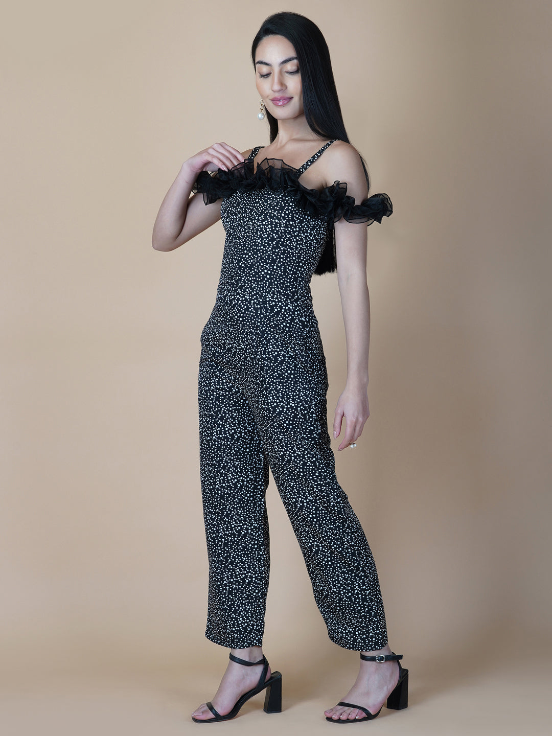 This black and white printed women's jumpsuit is the perfect combination of comfort and style. This jumpsuit features a tissue ruffle that adds a touch of feminine charm to the outfit. The jumpsuit has a sleeveless design with strap on shoulder, providing a stylish look