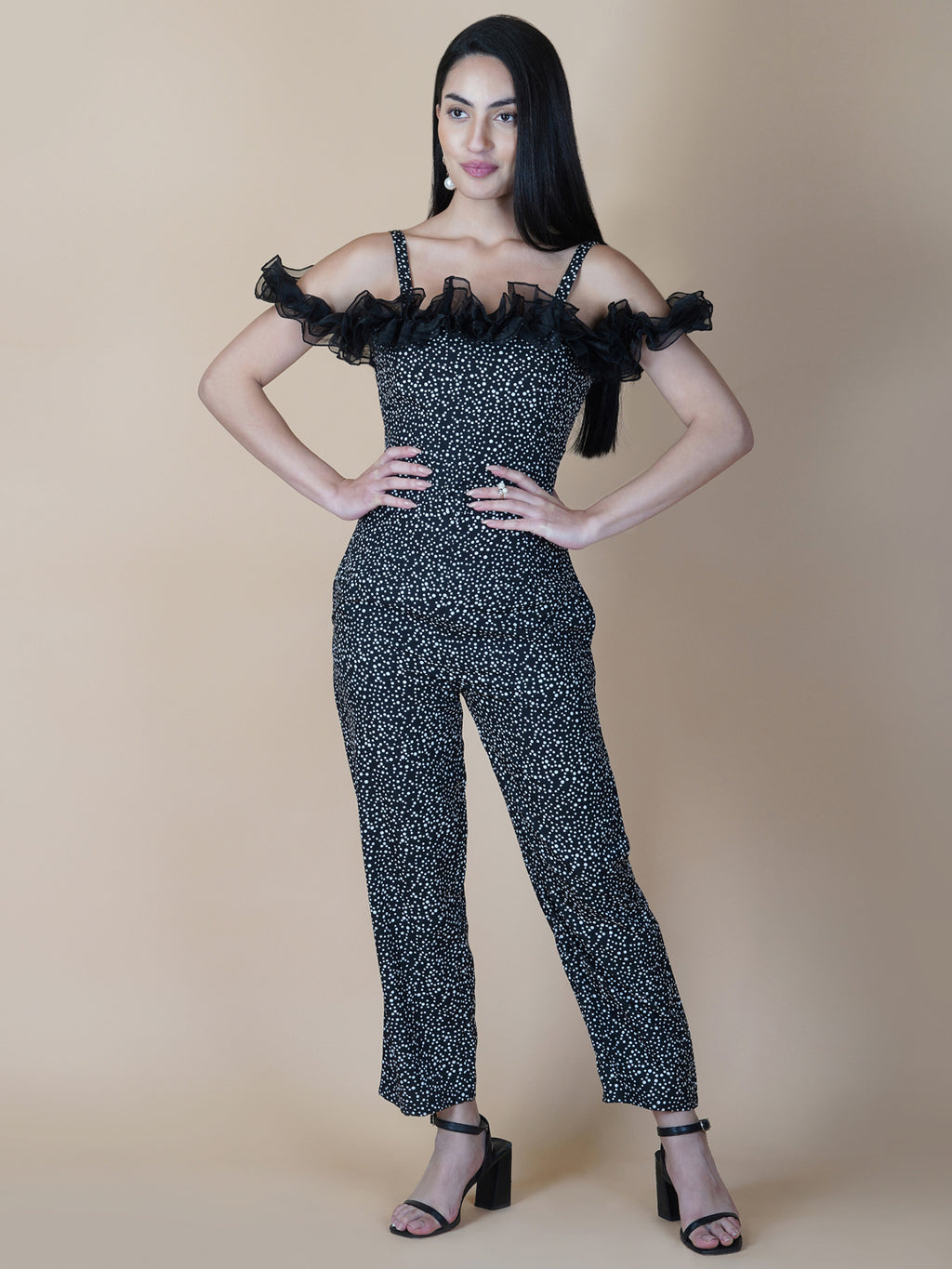 This black and white printed women's jumpsuit is the perfect combination of comfort and style. This jumpsuit features a tissue ruffle that adds a touch of feminine charm to the outfit. The jumpsuit has a sleeveless design with strap on shoulder, providing a stylish look