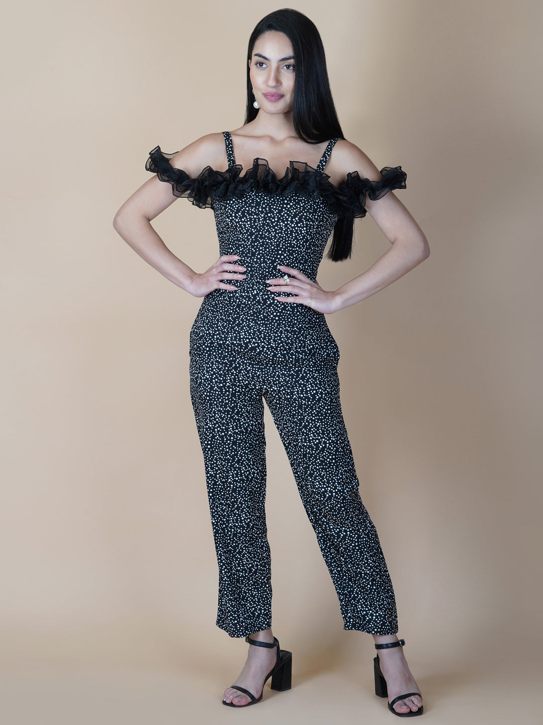 This black and white printed women's jumpsuit is the perfect combination of comfort and style. This jumpsuit features a tissue ruffle that adds a touch of feminine charm to the outfit. The jumpsuit has a sleeveless design with strap on shoulder, providing a stylish look