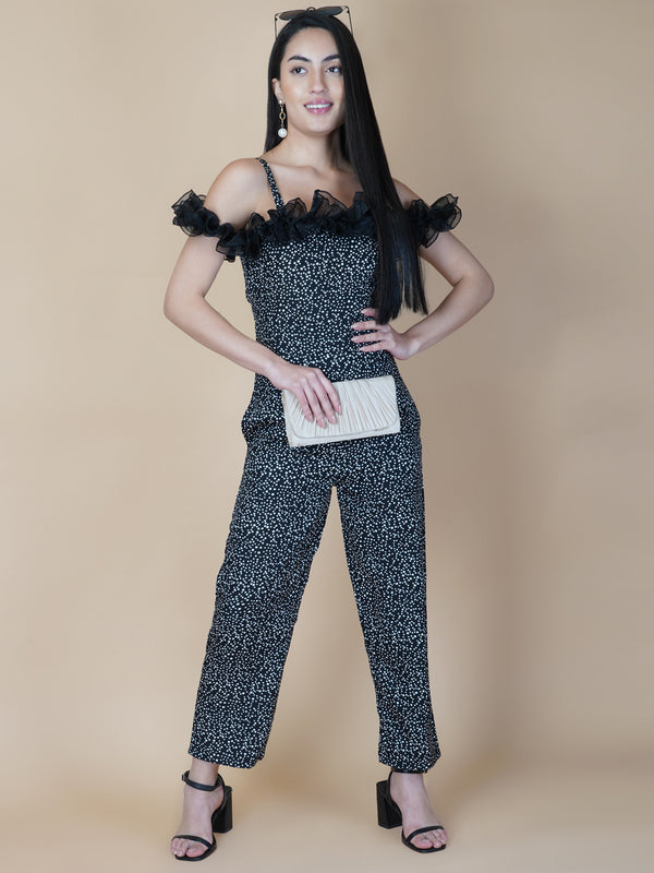 This black and white printed women's jumpsuit is the perfect combination of comfort and style. This jumpsuit features a tissue ruffle that adds a touch of feminine charm to the outfit. The jumpsuit has a sleeveless design with strap on shoulder, providing a stylish look
