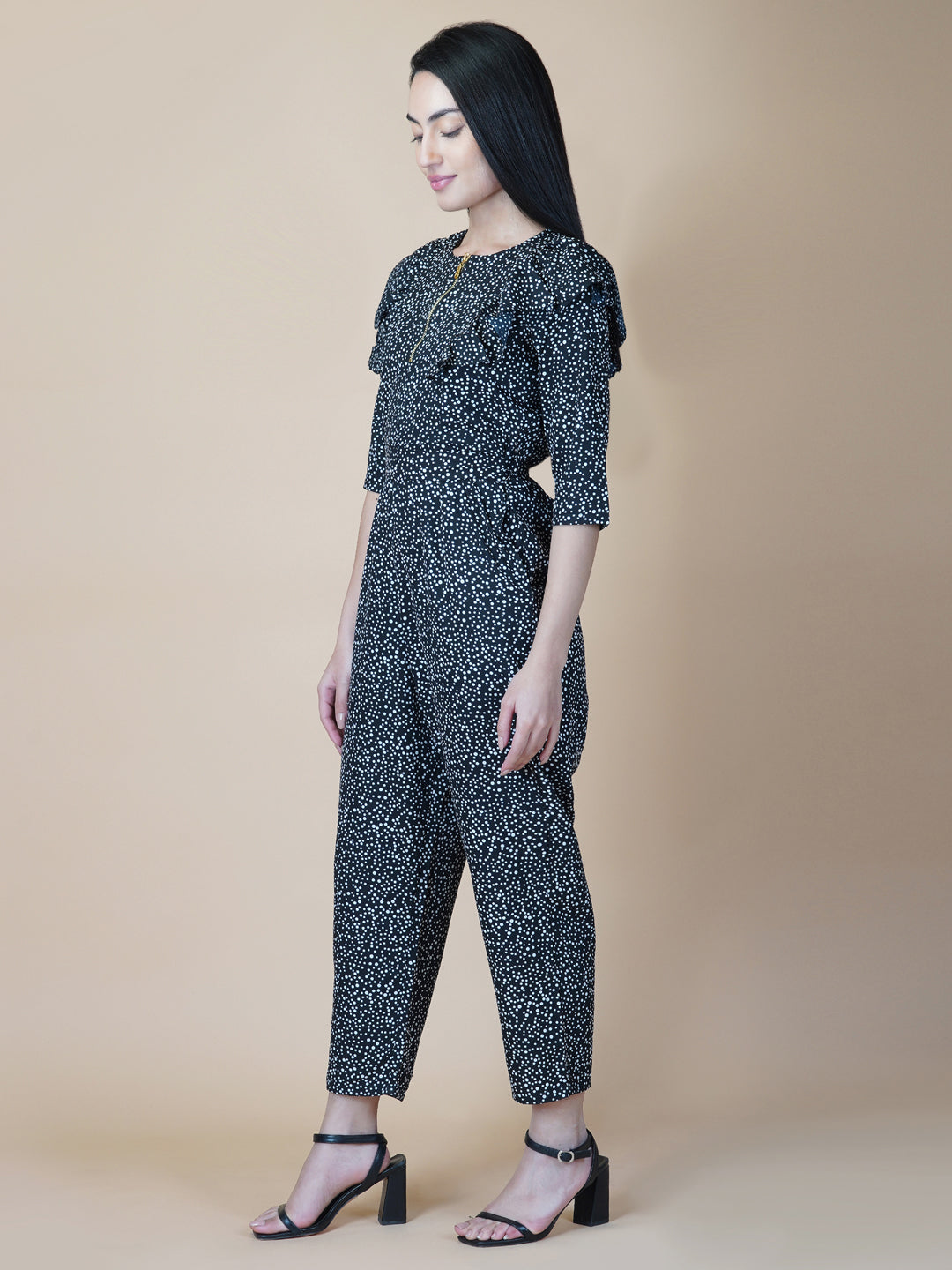 This black and white printed women jumpsuit is perfect for a stylish and chic look. The bow tie belt adds a touch of femininity, while the side ruffles add a playful element. It's made from a soft and lightweight material that's perfect for wearing all day long.