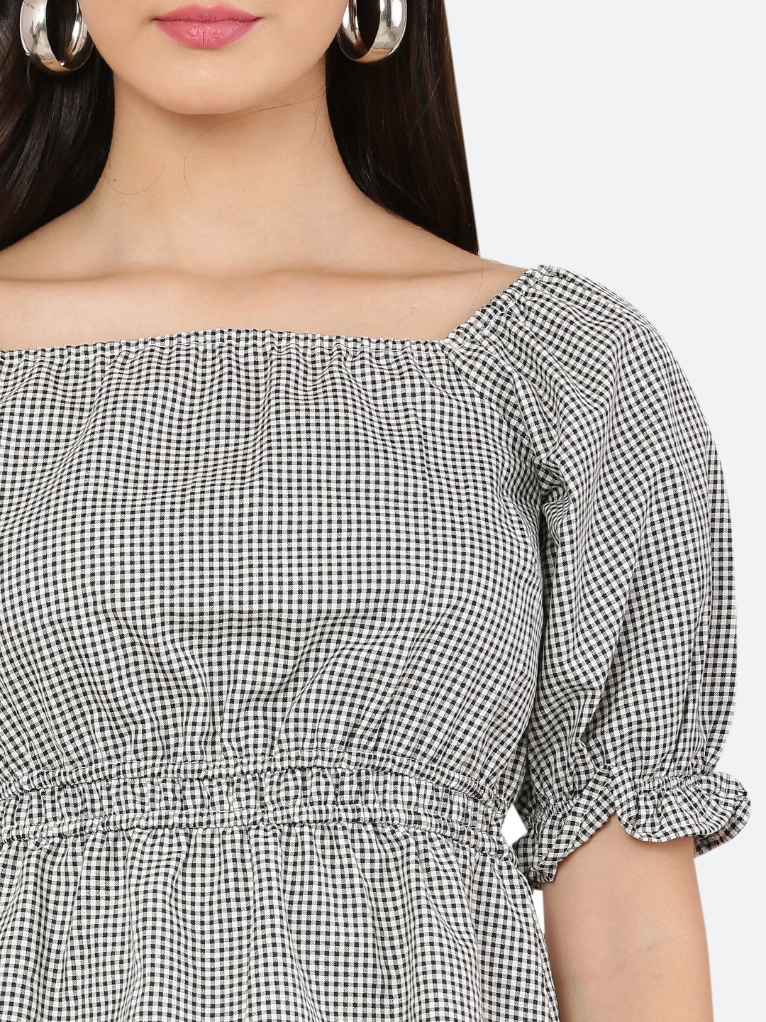 A grey gingham ruched waist women's top with gathered sleeves is a stylish and feminine garment. The top features a classic grey gingham pattern, with a fitted waistline that is gathered and ruched for a flattering silhouette. The gathered sleeves add a touch of volume and interest to the design.