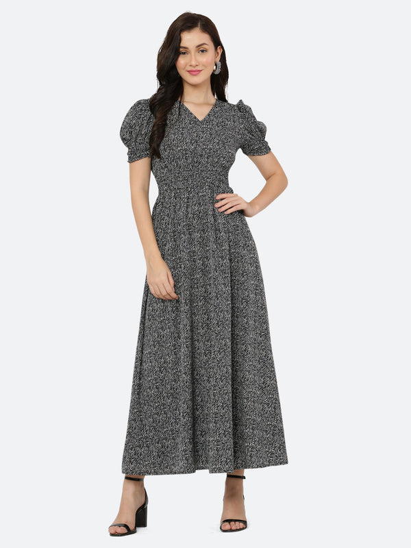This black printed maxi dress features an abstract print that adds a touch of sophistication to the silhouette. The ruched waist and sleeves create a flattering and feminine shape, while the attached lining provides comfort and coverage. Perfect for both formal and casual occasions, this dress can be styled with statement earrings, strappy heels, and a clutch for a chic and effortless look.