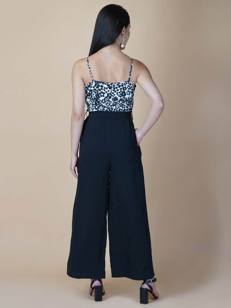 Black and white printed cowl neck jumpsuit is a stylish and versatile piece of clothing that can be worn for various occasions. It can be dressed up or down depending on the event and the accessories you choose to wear with it.