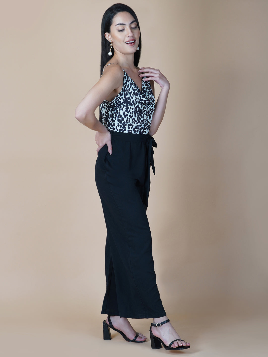 Black and white printed cowl neck jumpsuit is a stylish and versatile piece of clothing that can be worn for various occasions. It can be dressed up or down depending on the event and the accessories you choose to wear with it.