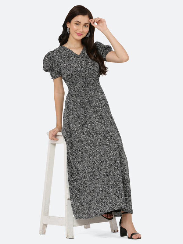 This black printed maxi dress features an abstract print that adds a touch of sophistication to the silhouette. The ruched waist and sleeves create a flattering and feminine shape, while the attached lining provides comfort and coverage. Perfect for both formal and casual occasions, this dress can be styled with statement earrings, strappy heels, and a clutch for a chic and effortless look.