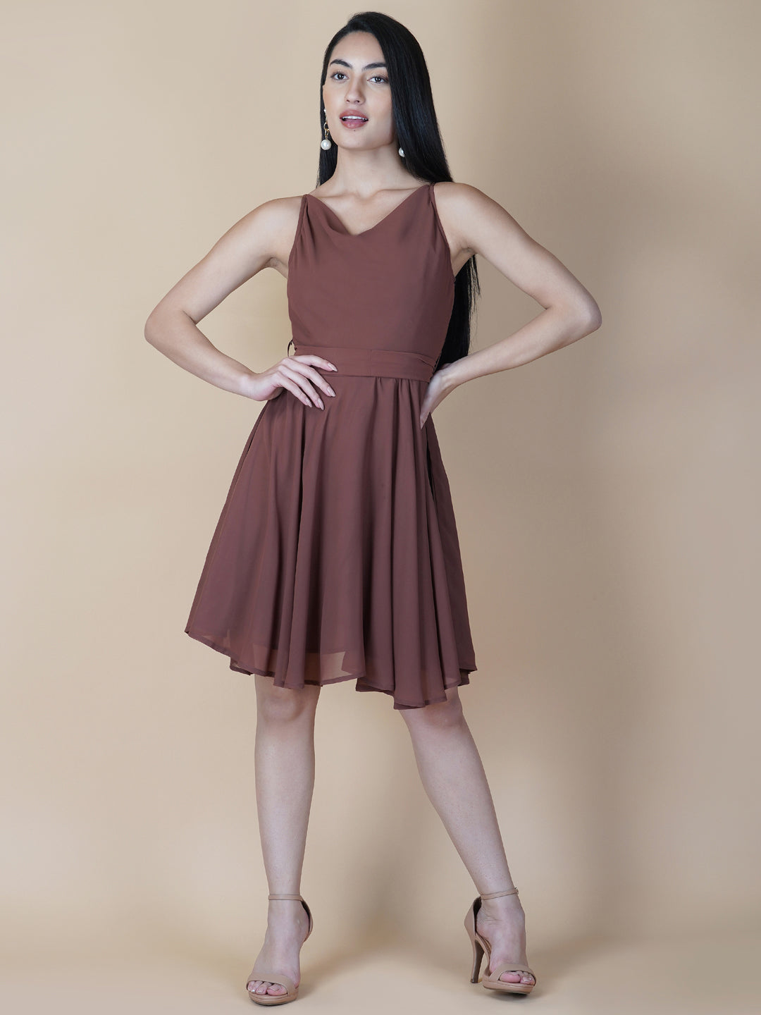 This beautiful brown color dress features a solid cowl neck design that drapes gracefully over the neckline. The circular hemline adds a unique touch to the dress, making it perfect for casual occasions.