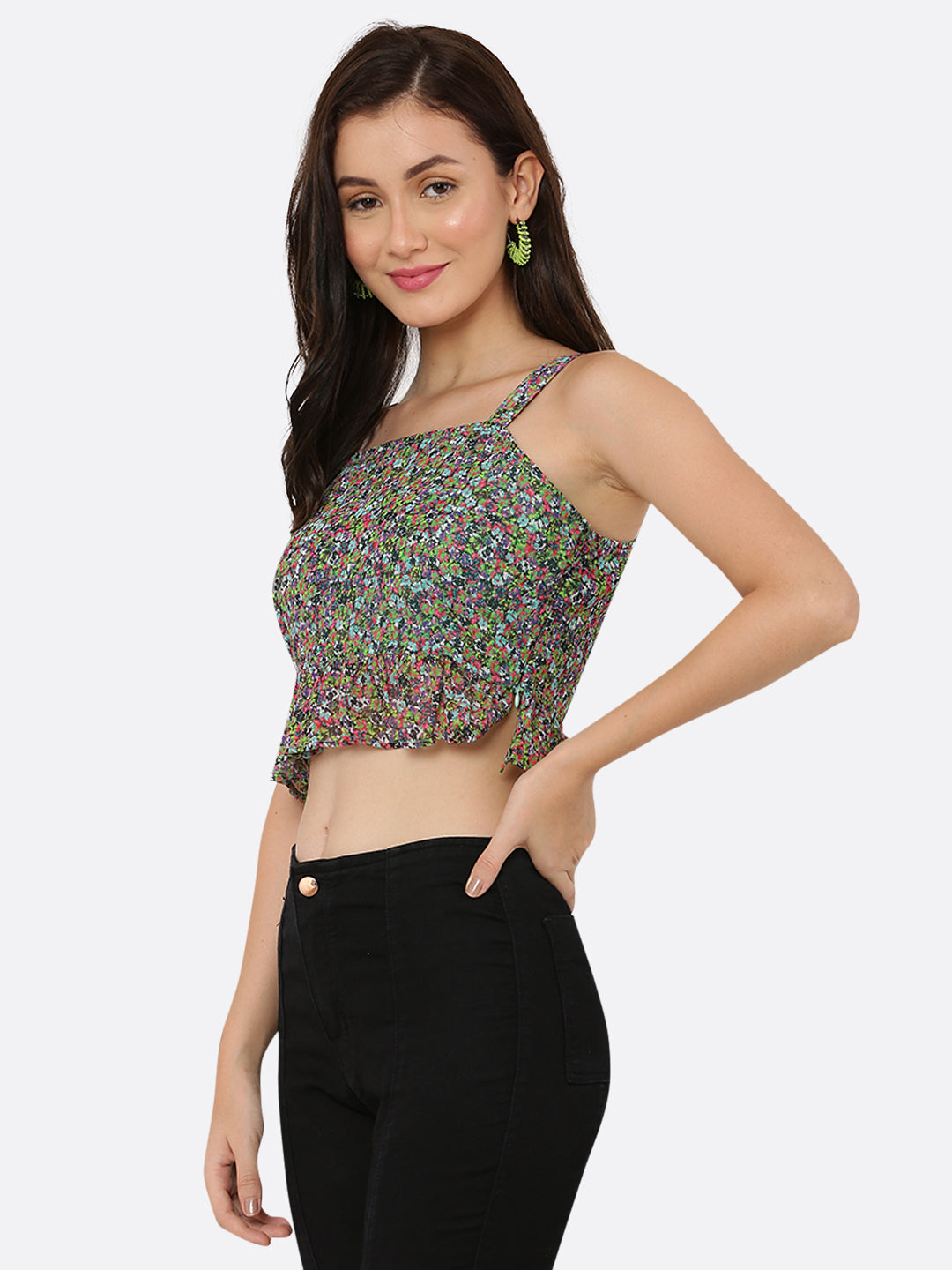 A green floral cami top for women with a frill at the waist is a stylish and feminine piece of clothing. The cami top is usually made of lightweight and breathable materials, making it perfect for warm weather.  The green floral pattern adds a pop of color and a touch of nature-inspired beauty to the top, while the frill at the waistline adds a playful and flirty touch.