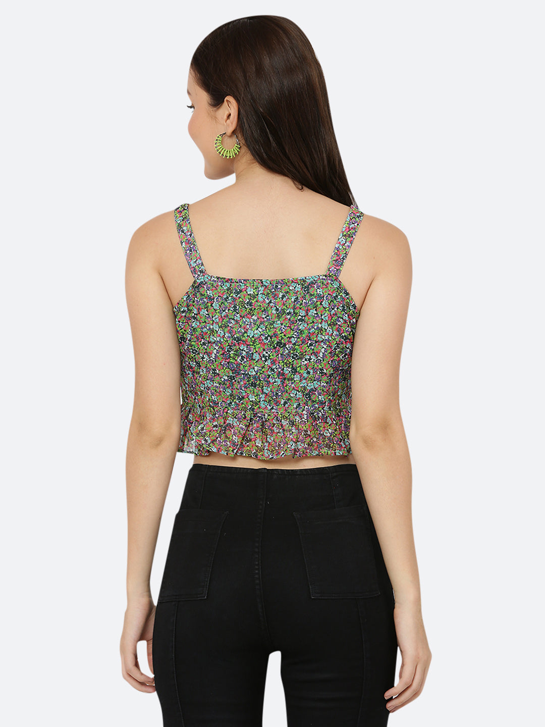A green floral cami top for women with a frill at the waist is a stylish and feminine piece of clothing. The cami top is usually made of lightweight and breathable materials, making it perfect for warm weather.  The green floral pattern adds a pop of color and a touch of nature-inspired beauty to the top, while the frill at the waistline adds a playful and flirty touch.