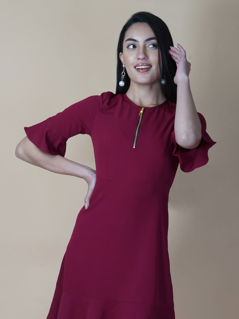 Burgundy Color A Line Women's Dress with a Metallic Zipper is a stylish and sophisticated garment that is perfect for a variety of occasions. The burgundy color is a rich and deep shade that adds a touch of elegance to the dress, while the A-line cut is flattering and comfortable.  The metallic zipper is a modern and eye-catching detail that adds a touch of edginess to the dress. It can be worn as a statement piece or paired with simple accessories to create a more subdued look.
