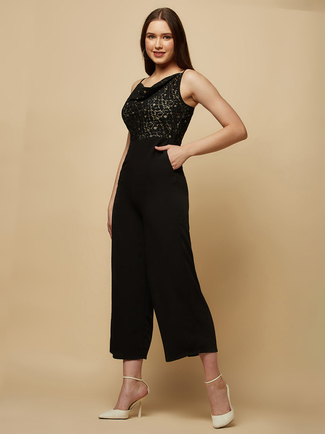 Black cowl neck women jumpsuit with jacquard mesh body and crepe pants is a fashionable piece of clothing that is both elegant and comfortable. The cowl neck provides a flattering neckline that is both feminine and sophisticated.  The jacquard mesh body adds a touch of glamour and texture to the piece, while the crepe pants provide a smooth and comfortable fit.