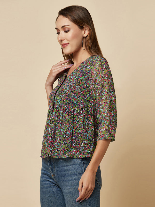 A Green printed top with a front placket and ruched bust line is a stylish and elegant piece of clothing. The top has a simple and classic design with a front placket that adds a touch of sophistication to the outfit. The ruched bust line creates a flattering and feminine look, enhancing the wearer's curves.