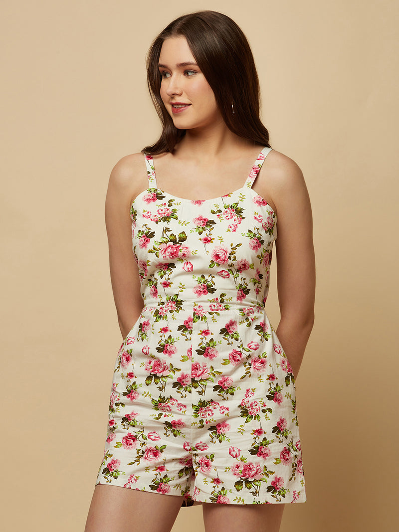 This white floral printed cotton jumpsuit is a perfect combination of style and comfort. The floral print adds a touch of femininity and elegance to the outfit, while the cotton fabric ensures breathability and ease of movement.  The jumpsuit features a back drawstring that allows for an adjustable fit, ensuring that it flatters your body shape perfectly. The drawstring also adds a touch of visual interest to the back of the jumpsuit, making it unique and eye-catching.
