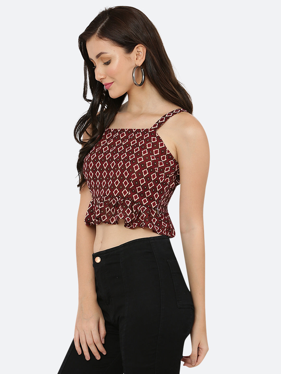 A green floral cami top for women with a frill at the waist is a stylish and feminine piece of clothing. The cami top is usually made of lightweight and breathable materials, making it perfect for warm weather.  The green floral pattern adds a pop of color and a touch of nature-inspired beauty to the top, while the frill at the waistline adds a playful and flirty touch.