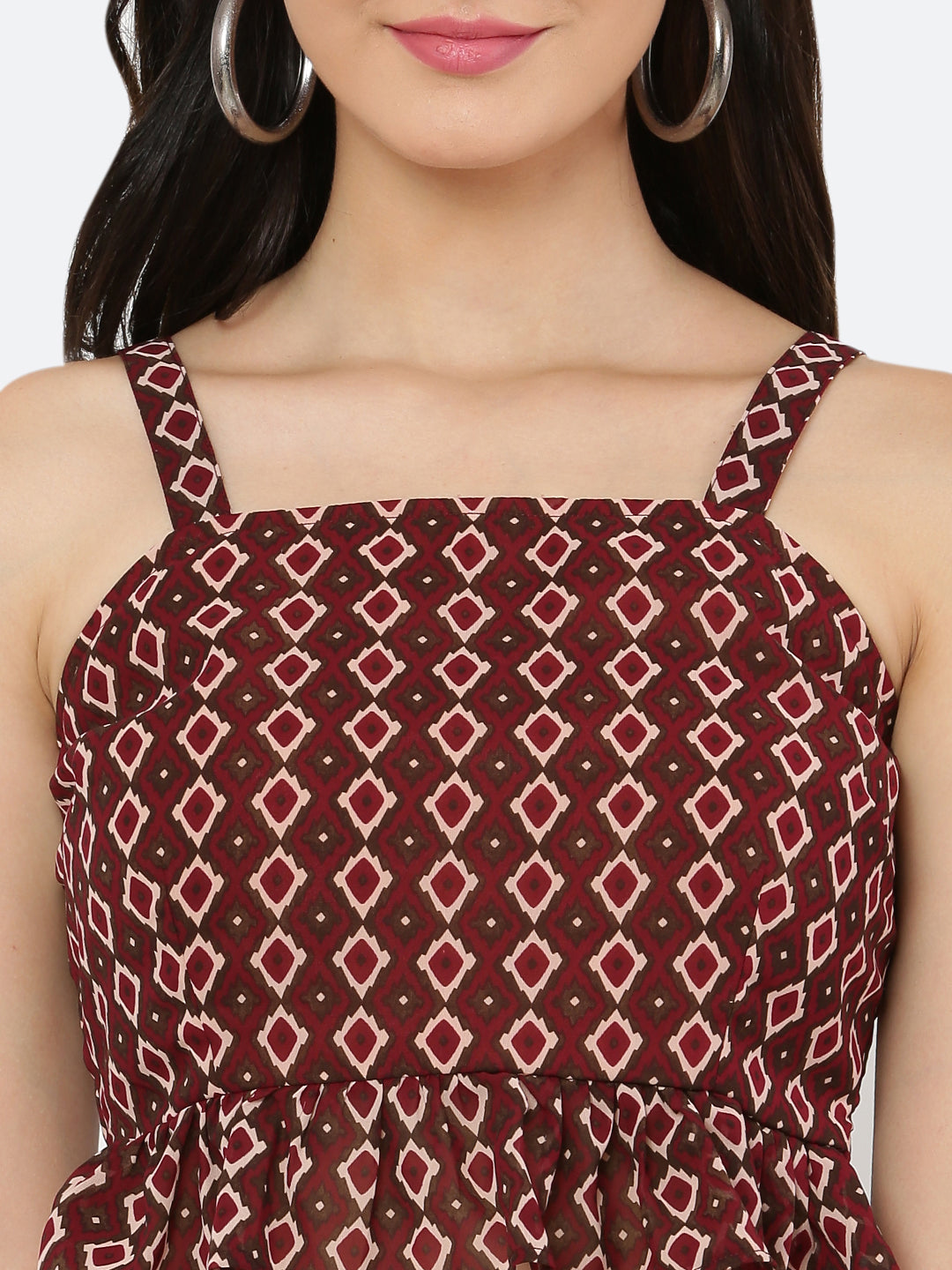 A green floral cami top for women with a frill at the waist is a stylish and feminine piece of clothing. The cami top is usually made of lightweight and breathable materials, making it perfect for warm weather.  The green floral pattern adds a pop of color and a touch of nature-inspired beauty to the top, while the frill at the waistline adds a playful and flirty touch.