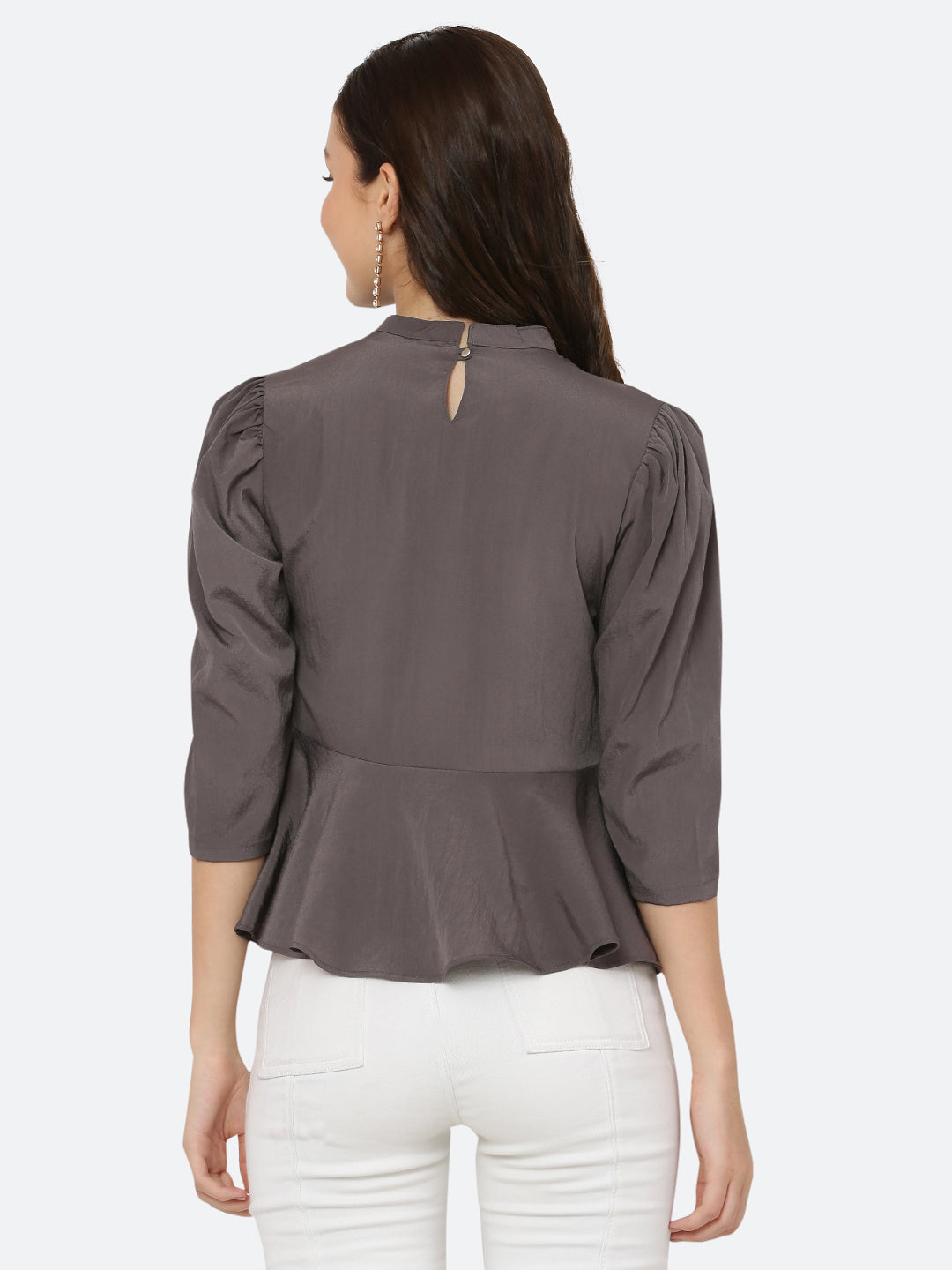 A grey colored women's top with a pleated neck and band collar is a stylish and sophisticated garment that can be worn for both casual and formal occasions. The pleated neck and band collar add a touch of elegance to the top, while the grey color gives it a classic and timeless look.