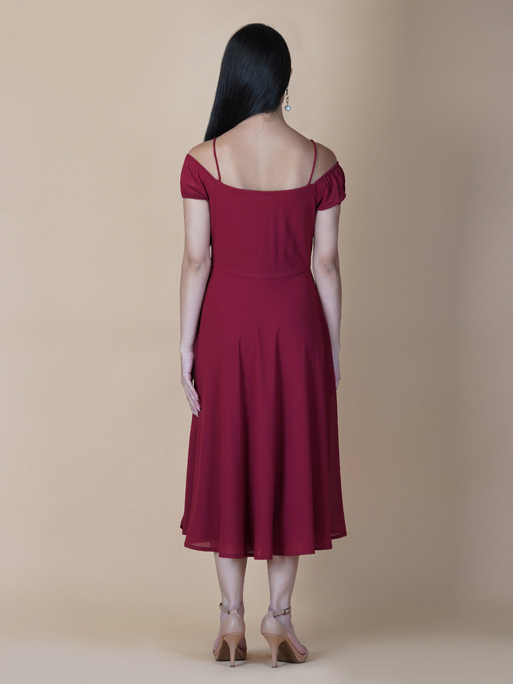 This dress features an off-shoulder neckline, a solid red color, and a circular hemline. The dress typically comes with an attached lining that provides coverage and support, while the circular hemline creates a flowy and elegant look.  The off-shoulder neckline is designed to showcase the shoulders and collarbone, creating a feminine and romantic look. The circular hemline adds movement and fluidity to the dress, making it perfect for dancing or twirling.
