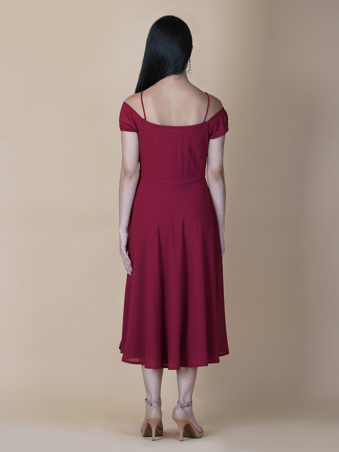 This dress features an off-shoulder neckline, a solid red color, and a circular hemline. The dress typically comes with an attached lining that provides coverage and support, while the circular hemline creates a flowy and elegant look.  The off-shoulder neckline is designed to showcase the shoulders and collarbone, creating a feminine and romantic look. The circular hemline adds movement and fluidity to the dress, making it perfect for dancing or twirling.