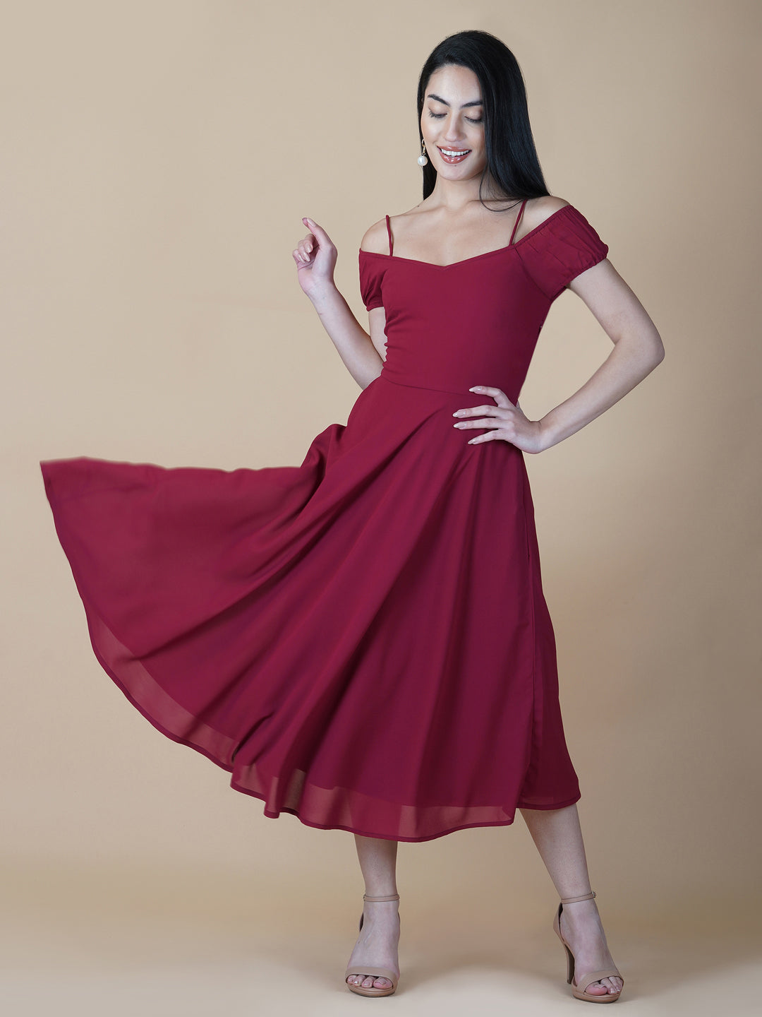 This dress features an off-shoulder neckline, a solid red color, and a circular hemline. The dress typically comes with an attached lining that provides coverage and support, while the circular hemline creates a flowy and elegant look.  The off-shoulder neckline is designed to showcase the shoulders and collarbone, creating a feminine and romantic look. The circular hemline adds movement and fluidity to the dress, making it perfect for dancing or twirling.
