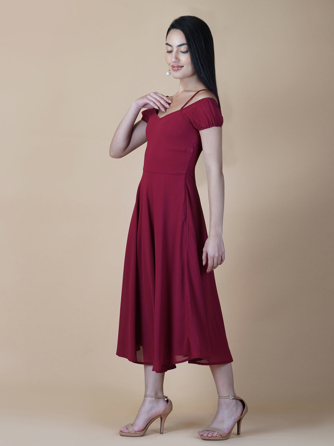 This dress features an off-shoulder neckline, a solid red color, and a circular hemline. The dress typically comes with an attached lining that provides coverage and support, while the circular hemline creates a flowy and elegant look.  The off-shoulder neckline is designed to showcase the shoulders and collarbone, creating a feminine and romantic look. The circular hemline adds movement and fluidity to the dress, making it perfect for dancing or twirling.