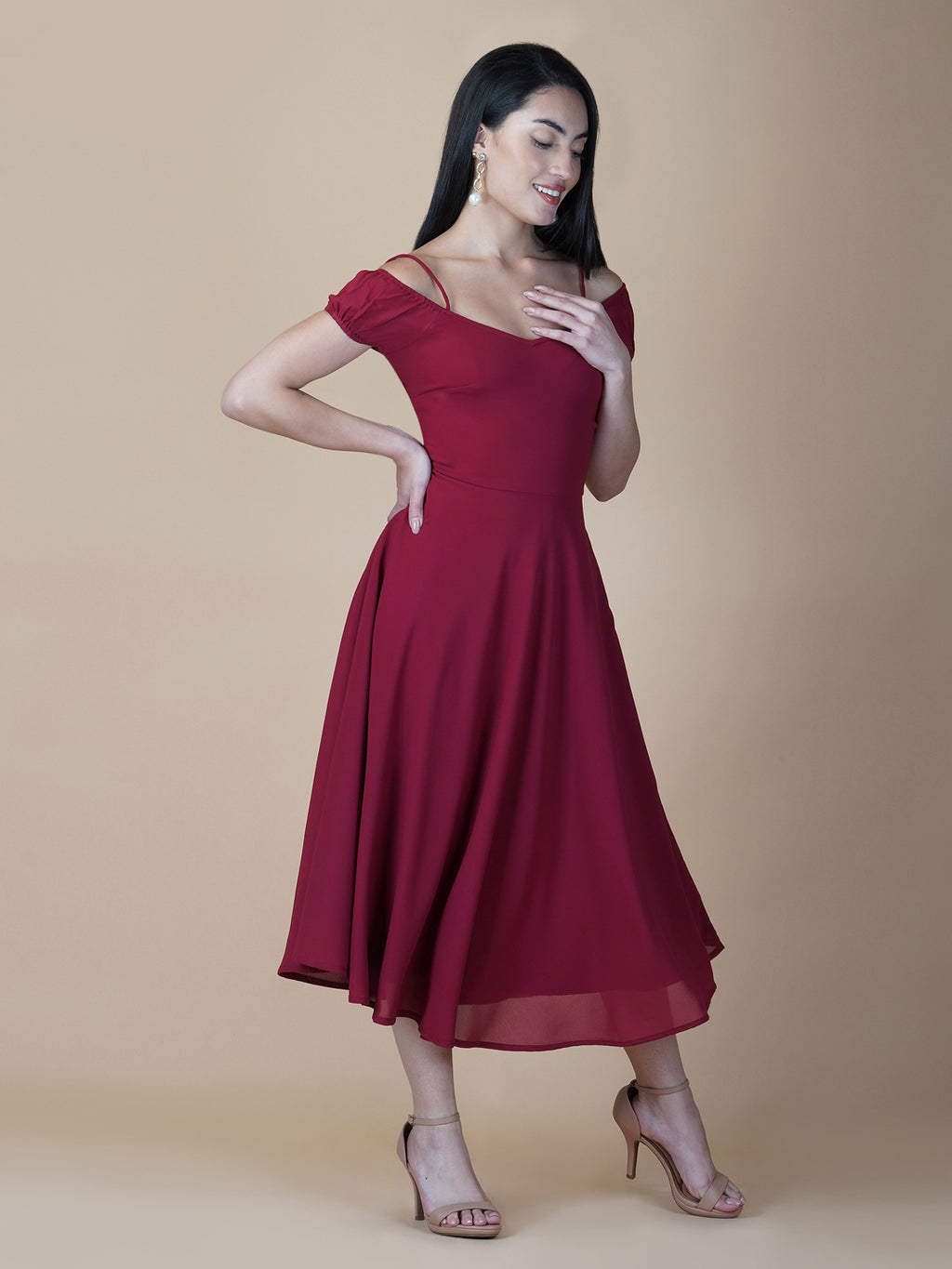 This dress features an off-shoulder neckline, a solid red color, and a circular hemline. The dress typically comes with an attached lining that provides coverage and support, while the circular hemline creates a flowy and elegant look.  The off-shoulder neckline is designed to showcase the shoulders and collarbone, creating a feminine and romantic look. The circular hemline adds movement and fluidity to the dress, making it perfect for dancing or twirling.