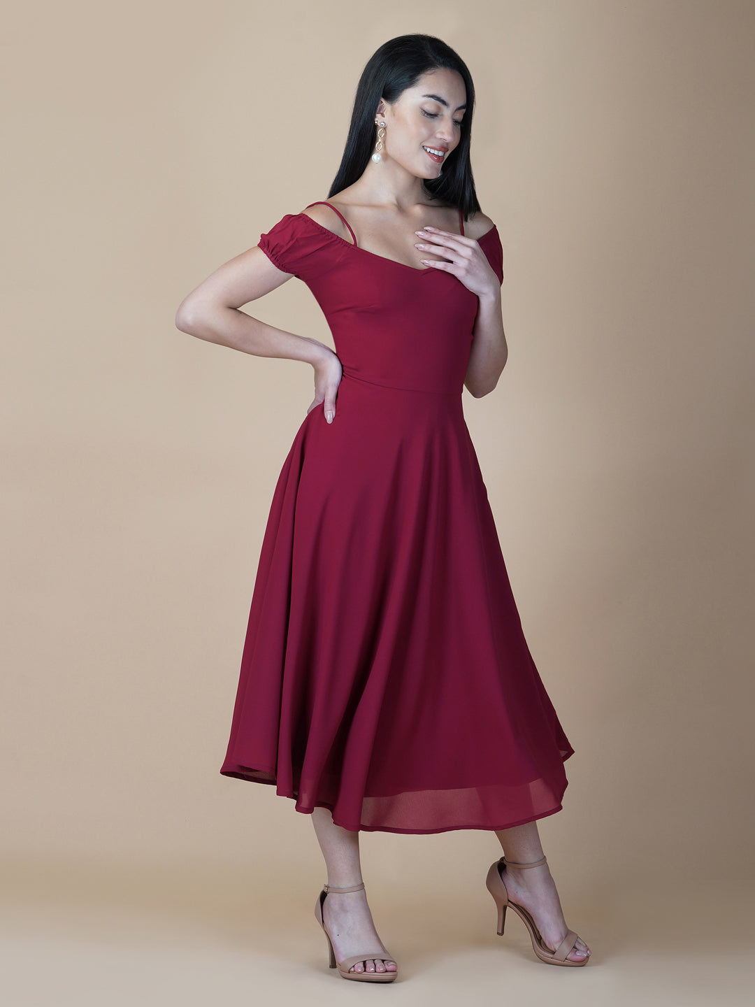 This dress features an off-shoulder neckline, a solid red color, and a circular hemline. The dress typically comes with an attached lining that provides coverage and support, while the circular hemline creates a flowy and elegant look.  The off-shoulder neckline is designed to showcase the shoulders and collarbone, creating a feminine and romantic look. The circular hemline adds movement and fluidity to the dress, making it perfect for dancing or twirling.