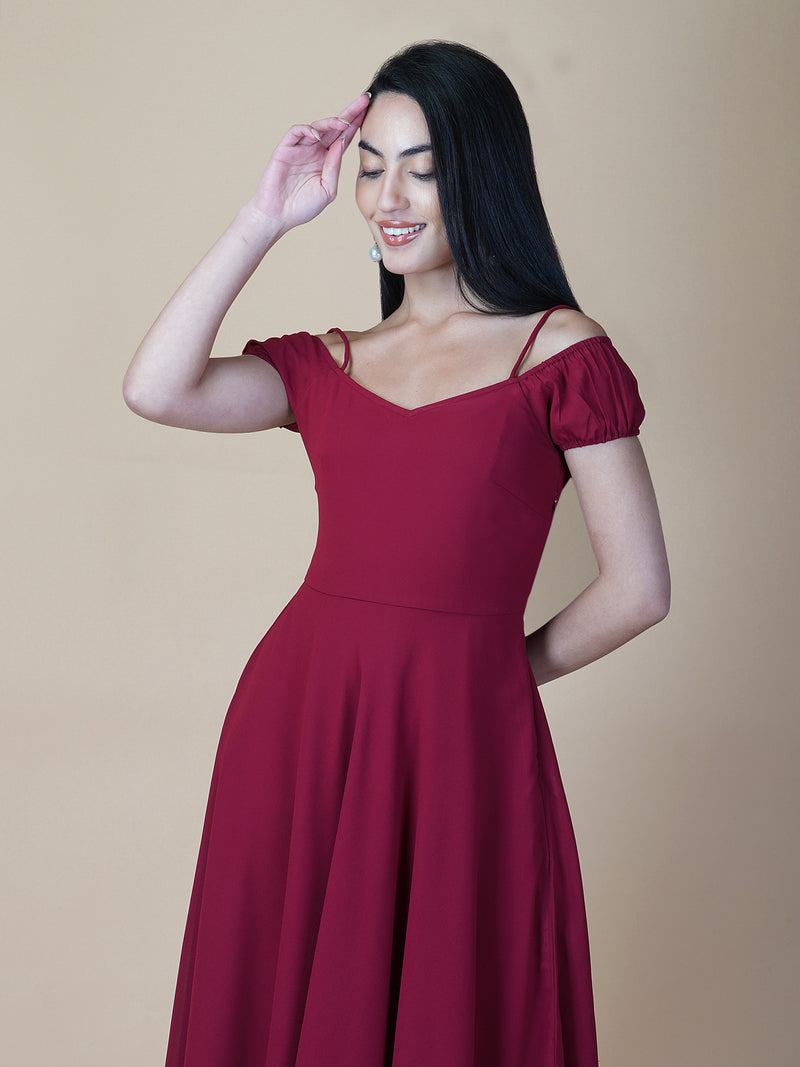 This dress features an off-shoulder neckline, a solid red color, and a circular hemline. The dress typically comes with an attached lining that provides coverage and support, while the circular hemline creates a flowy and elegant look.  The off-shoulder neckline is designed to showcase the shoulders and collarbone, creating a feminine and romantic look. The circular hemline adds movement and fluidity to the dress, making it perfect for dancing or twirling.