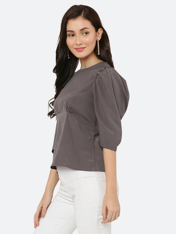 A ruched waist women's top typically features gathering or pleating at the waistline, which creates a snug and flattering fit. The top may be made from a variety of fabrics and come in different colors, but the grey color is a popular choice.