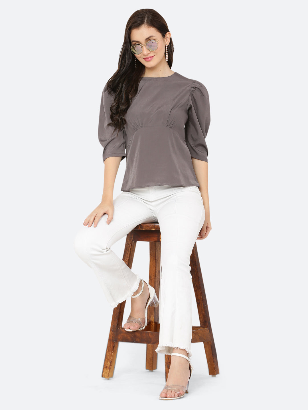 A ruched waist women's top typically features gathering or pleating at the waistline, which creates a snug and flattering fit. The top may be made from a variety of fabrics and come in different colors, but the grey color is a popular choice.
