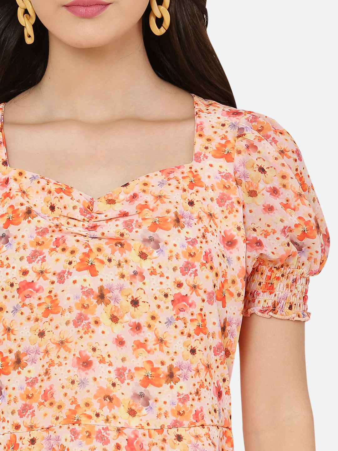 This dress features a circular hemline that adds a playful, flirty feel to the overall design. The ruched neckline and smocked sleeves add texture and dimension to the dress, while also providing a snug and comfortable fit. Perfect for summer days and breezy evenings, this dress is versatile and easy to wear, making it a must-have in your wardrobe.