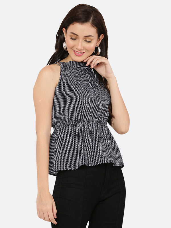 A blue printed halter neck top with a ruched waist typically refers to a sleeveless top that has a high neckline that ties at the back of the neck, leaving the shoulders and upper back exposed. The top is often fitted around the bust and waist, with ruching or gathering at the waistline to create a flattering and feminine silhouette.