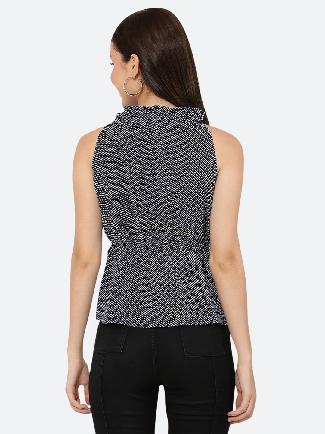 A blue printed halter neck top with a ruched waist typically refers to a sleeveless top that has a high neckline that ties at the back of the neck, leaving the shoulders and upper back exposed. The top is often fitted around the bust and waist, with ruching or gathering at the waistline to create a flattering and feminine silhouette.