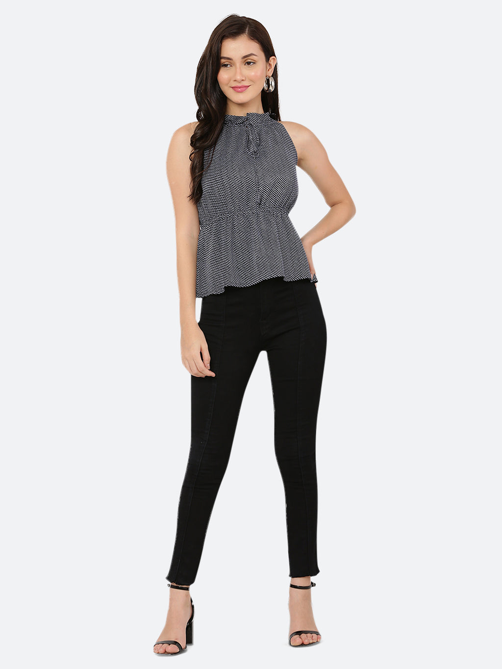 A blue printed halter neck top with a ruched waist typically refers to a sleeveless top that has a high neckline that ties at the back of the neck, leaving the shoulders and upper back exposed. The top is often fitted around the bust and waist, with ruching or gathering at the waistline to create a flattering and feminine silhouette.