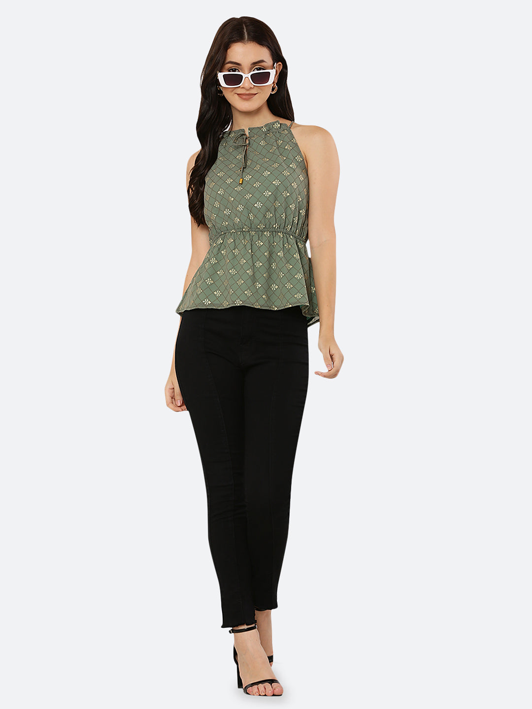 Green Foil printed halter neck top for women with a ruched waist and drawstring is a stylish and versatile piece of clothing. The halter neck design creates a flattering silhouette by accentuating the shoulders and neckline while the ruched waistline cinches in the waist and creates an hourglass shape. The drawstring allows for a customizable fit, making this top suitable for a range of body types.