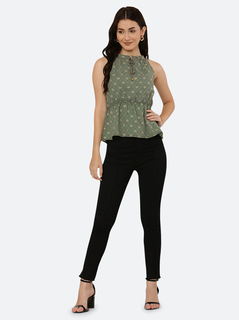 Green Foil printed halter neck top for women with a ruched waist and drawstring is a stylish and versatile piece of clothing. The halter neck design creates a flattering silhouette by accentuating the shoulders and neckline while the ruched waistline cinches in the waist and creates an hourglass shape. The drawstring allows for a customizable fit, making this top suitable for a range of body types.